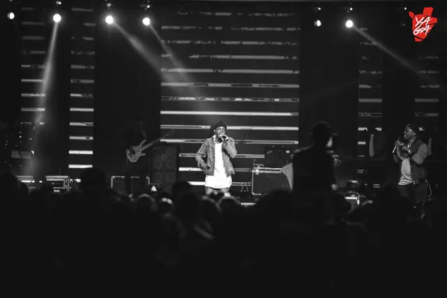 Wide shot of Paddy Daniel performing with a full band, black and white