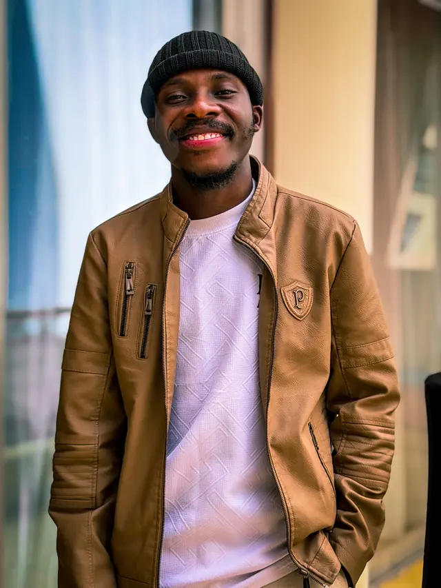 Paddy Daniel in a tan jacket and black beanie
