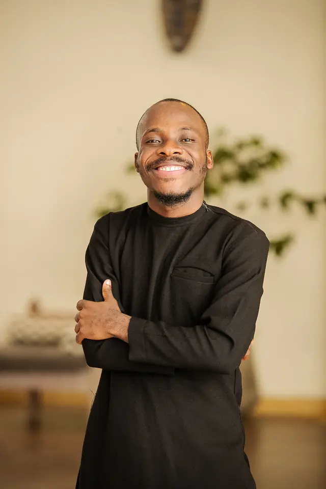 Paddy Daniel smiling in a black kaftan
