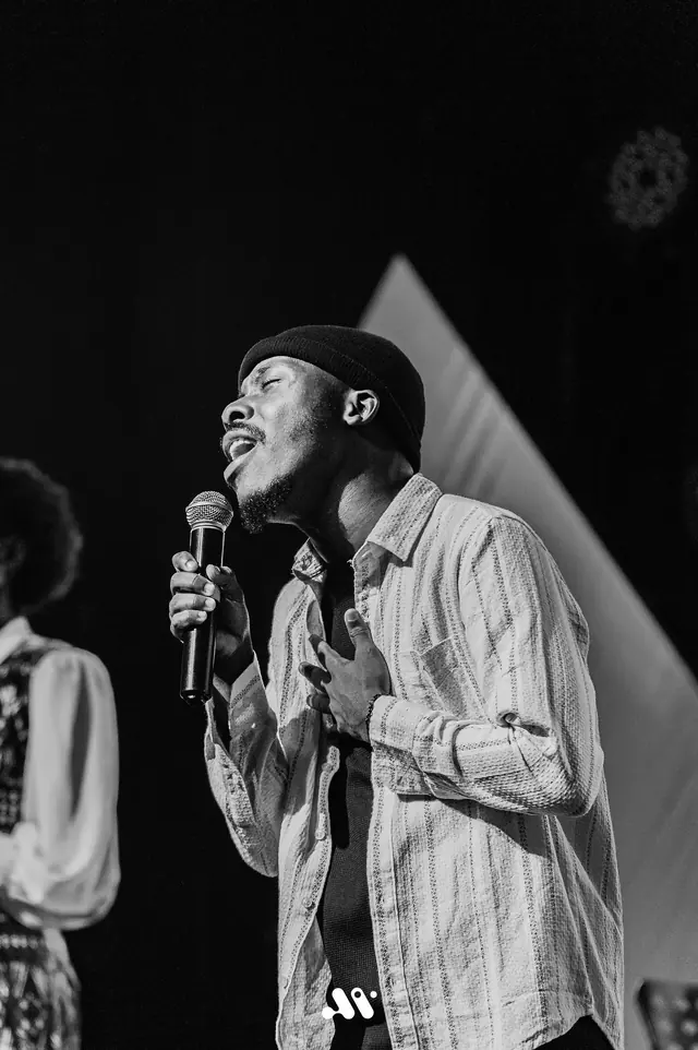 Paddy Daniel singing with eyes closed, black and white